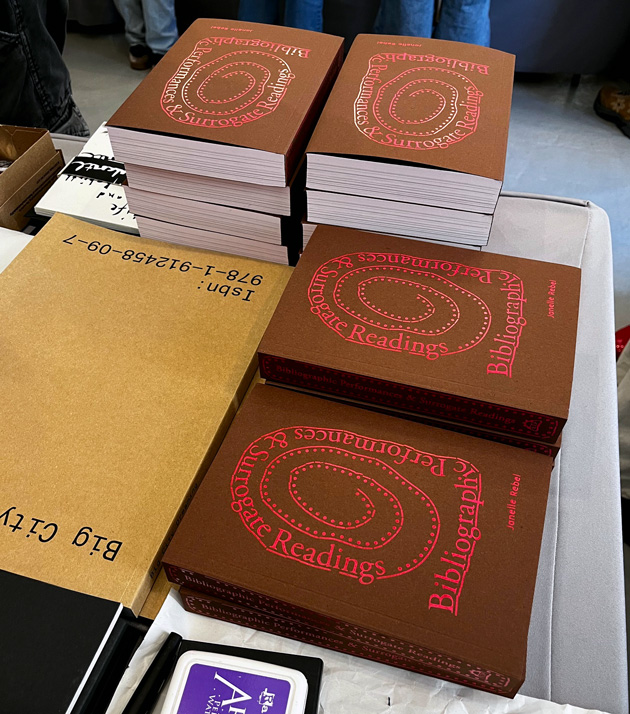 books stacked on the table at the New York Art Book Fair